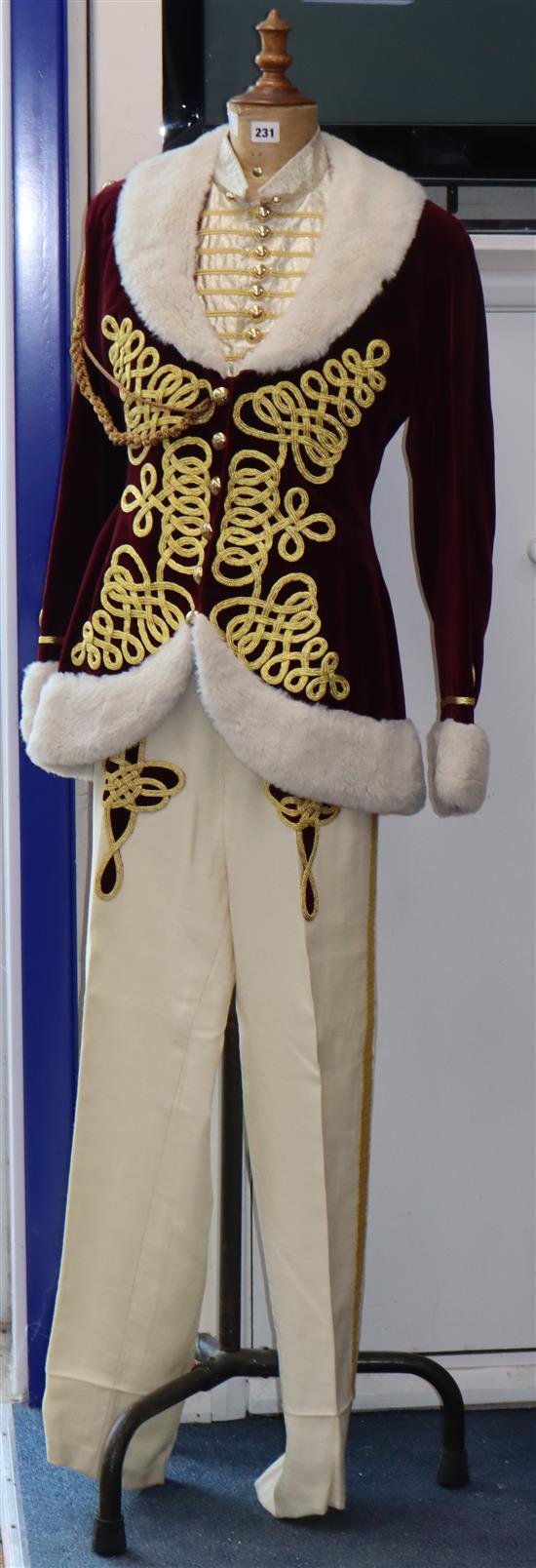 Fledermaus: Prince Orlofskys maroon velvet jacket, trimmed with gold braid and white fur trim, a matching silver and gold waistcoat an